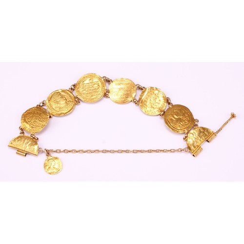 601 - A high carat gold bracelet, containing an arrangement of seven Byzantine and other similar gold coin... 