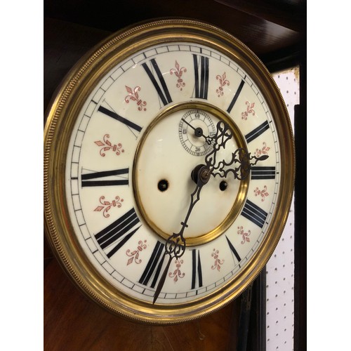 1977 - A late 19th century walnut Vienna wall clock, cream dial, Roman numerals, two train eight day moveme... 