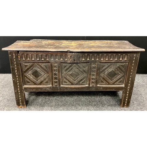 1680 - A Charles II carved oak coffer or blanket chest, single plank top, three carved panels to front, car... 