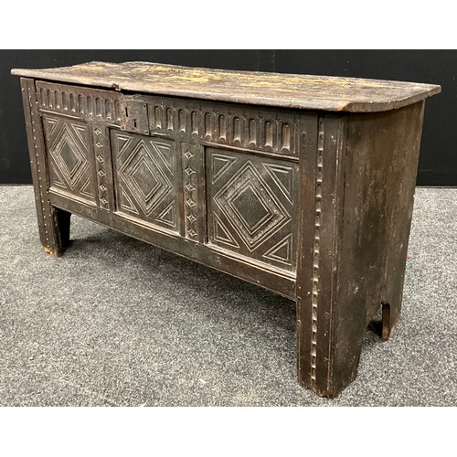 1680 - A Charles II carved oak coffer or blanket chest, single plank top, three carved panels to front, car... 