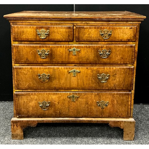 1541 - A George II walnut chest of drawers, the slightly over-sailing top with out-swept frieze, above a pa... 