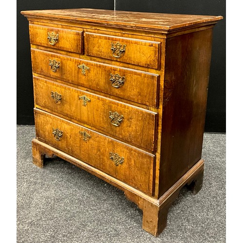 1541 - A George II walnut chest of drawers, the slightly over-sailing top with out-swept frieze, above a pa... 