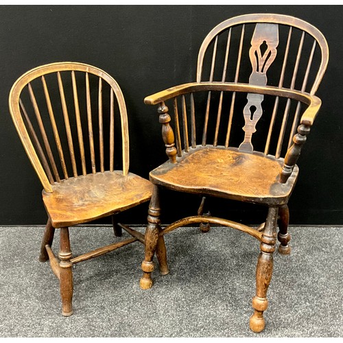 1570 - An early 19th century elm Windsor chair, crinoline stretcher, 93cm high, 47.5cm wide; a small elm Wi... 