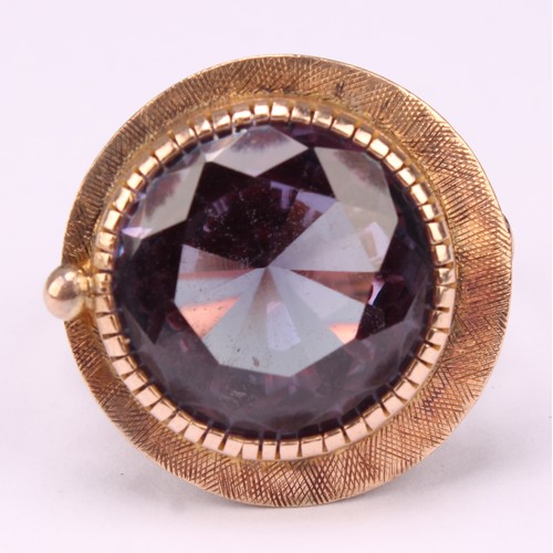 543 - A bespoke 14k rose gold ring, set slightly off centre with a large faceted amethyst, hand engraved b... 