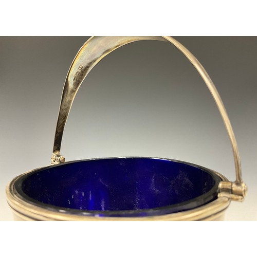 342 - A George III silver sugar basket, blue glass liner, swing handle, TW, London 1812, 20.5cm high overa... 