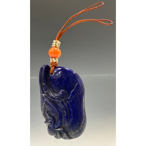 547 - A carved lapis lazuli and coral tablet pendant, relief carved with stylised Frog and blossoming flow... 