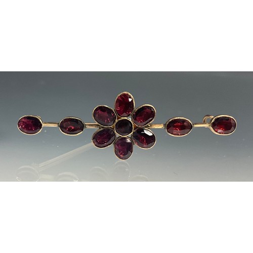 529 - A 19th century pink garnet brooch, central flowerhead of a single round stone surrounded by six oval... 