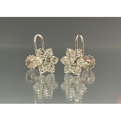 618 - A pair of diamond cluster earrings, each set with seven round brilliant cut diamonds, total estimate... 