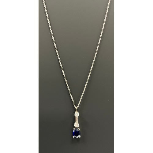 552 - A diamond and blue stone, possibly sapphire, pendant necklace, with two round brilliant cut diamonds... 