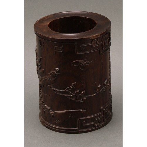 1398 - A Chinese hardwood scholar's bitong brush pot,  carved in relief with phoenix, flowers, trellis, pru... 