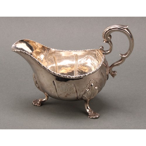 122 - A George III Irish silver sauce boat, of substantial gauge, acanthus-capped scroll handle, gadrooned... 