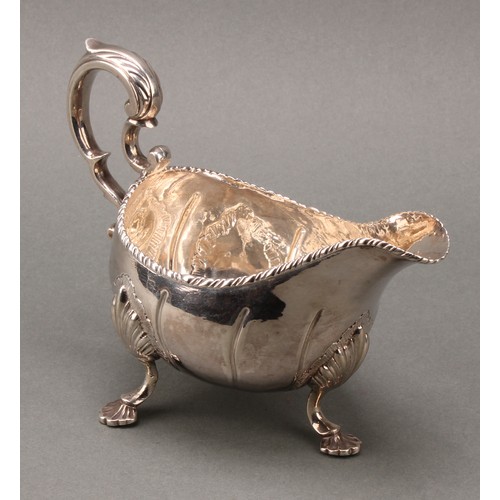 122 - A George III Irish silver sauce boat, of substantial gauge, acanthus-capped scroll handle, gadrooned... 