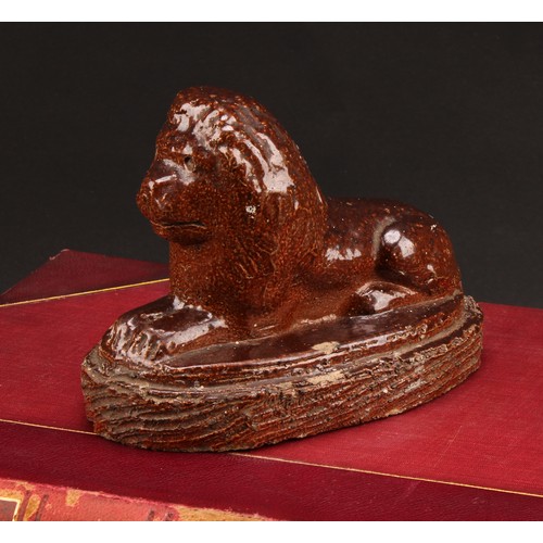 1259 - A 19th century brown salt glazed stone ware model, of a recumbent lion, oval base, 16.5cm wide