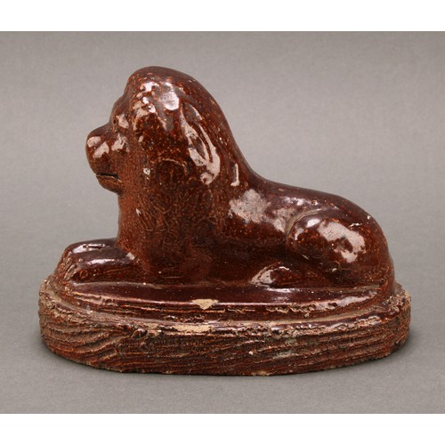 1259 - A 19th century brown salt glazed stone ware model, of a recumbent lion, oval base, 16.5cm wide