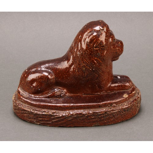 1259 - A 19th century brown salt glazed stone ware model, of a recumbent lion, oval base, 16.5cm wide