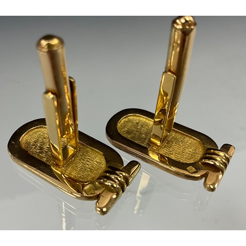 621 - A pair of Egyptian gold coloured metal cufflinks, the tops with three character hieroglyph, stamped ... 