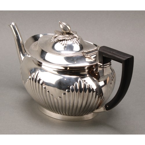 316 - A Victorian silver half-fluted lamp shaped teapot, acorn finial above hinged cover, angled handle, f... 