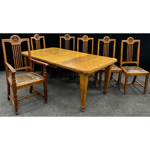 2143 - An Arts and Crafts oak dining suite, canted rectangular top, wind-out mechanism with two additional ... 