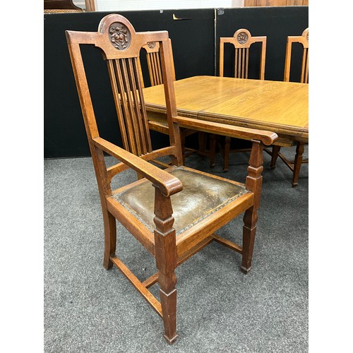 2143 - An Arts and Crafts oak dining suite, canted rectangular top, wind-out mechanism with two additional ... 