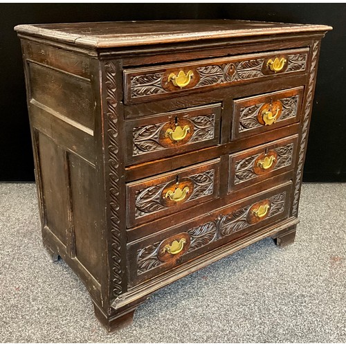 1638 - A mid 17th century oak chest of drawers, with some later alterations, ornately carved, panelled side... 