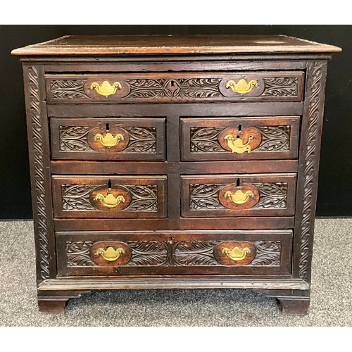 1638 - A mid 17th century oak chest of drawers, with some later alterations, ornately carved, panelled side... 