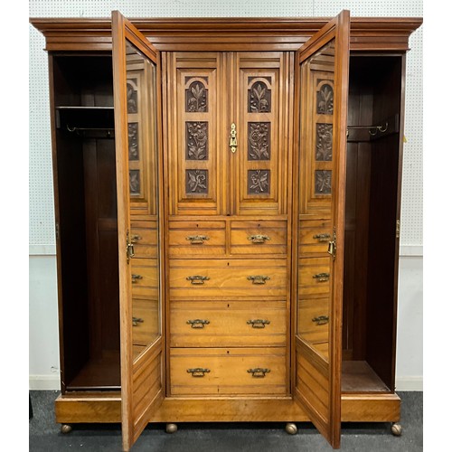 1619 - A Victorian carved walnut wardrobe, moulded cornice, above a central linen-press section, with carve... 