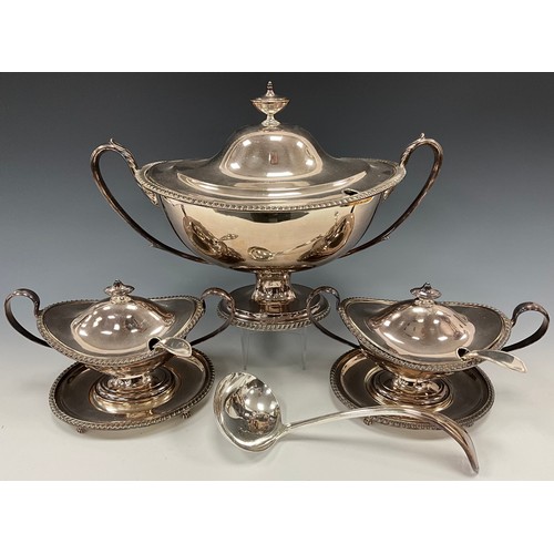 42 - A set of three George III style silver plated covered tureens and ladles, comprising twin handled ov... 