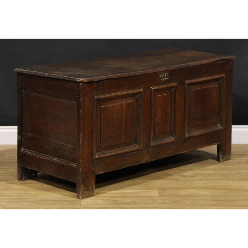 1628 - An 18th century oak blanket chest, hinged top above three raised and fielded panels, stile feet, 65c... 