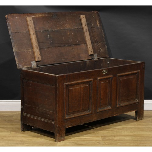 1628 - An 18th century oak blanket chest, hinged top above three raised and fielded panels, stile feet, 65c... 