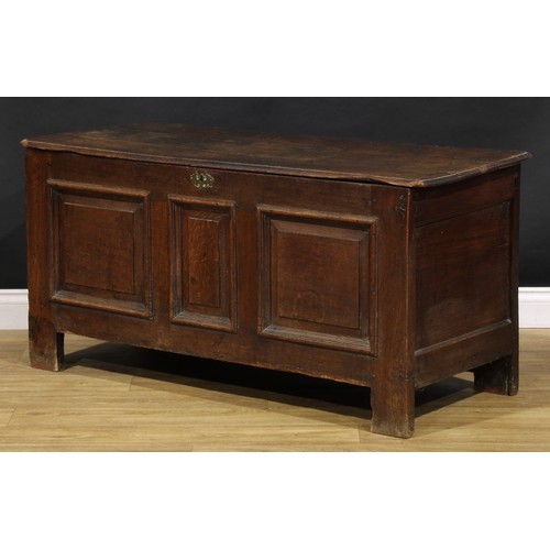 1628 - An 18th century oak blanket chest, hinged top above three raised and fielded panels, stile feet, 65c... 