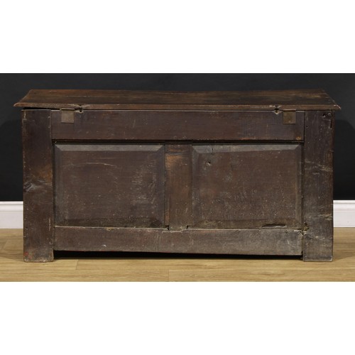 1628 - An 18th century oak blanket chest, hinged top above three raised and fielded panels, stile feet, 65c... 