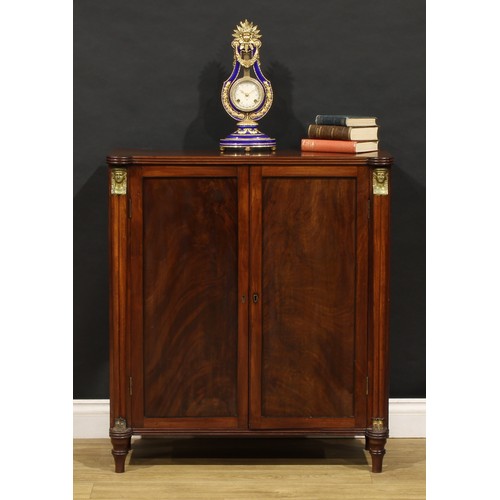 1596 - A 19th century mahogany enclosed pier cabinet or library bookcase, in the Regency Egyptian Revival t... 