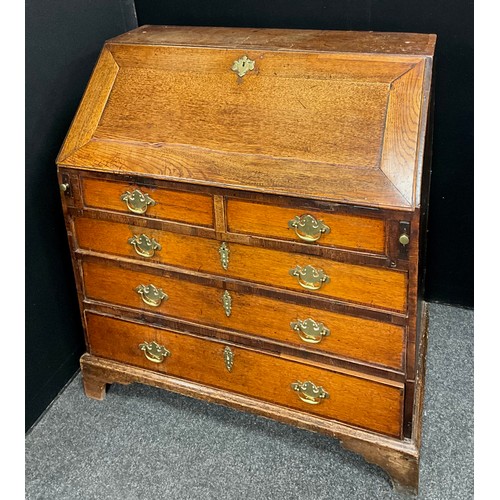 1907 - A Georgian III oak and elm bureau, the fall front enclosing a fully fitted interior, with central ar... 