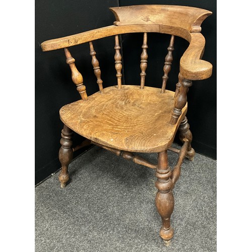 1573 - An early 20th century elm Captains’ or smoker’s bow armchair.