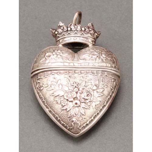 307 - A Danish silver coloured metal heart shaped hovedvandsaeg marriage box, chased with flowers and leav... 