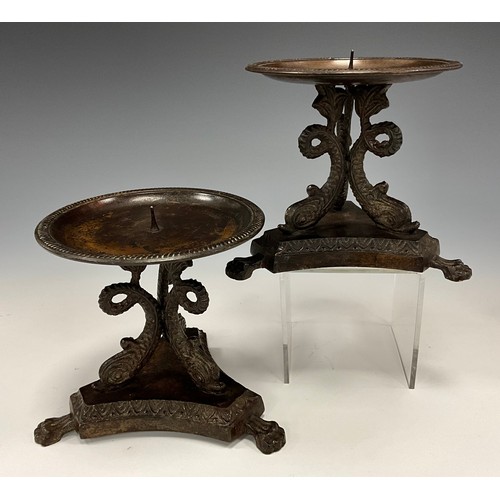 1850 - A pair of bronze pricket candlesticks, tripod fish columns, inverted triangular base, paw feet, 11.4... 