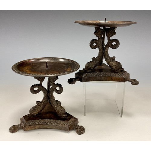 1850 - A pair of bronze pricket candlesticks, tripod fish columns, inverted triangular base, paw feet, 11.4... 