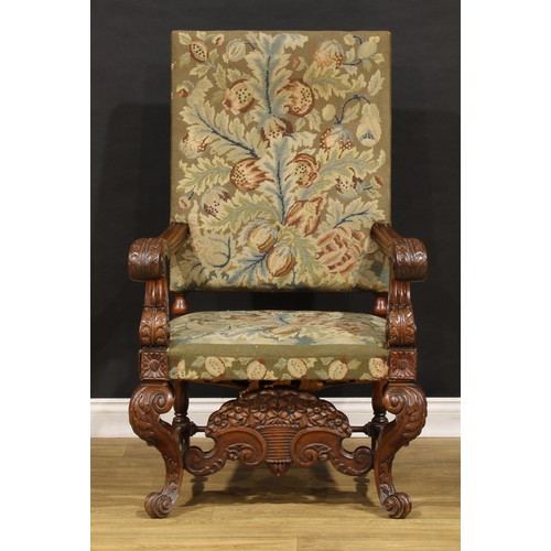 1912 - A substantial French Baroque walnut armchair, the bold scroll arms and cabriole legs carved with aca... 