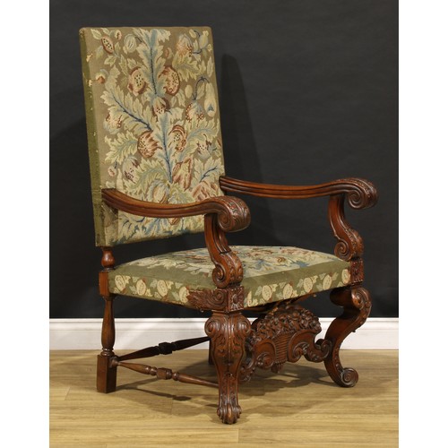 1912 - A substantial French Baroque walnut armchair, the bold scroll arms and cabriole legs carved with aca... 