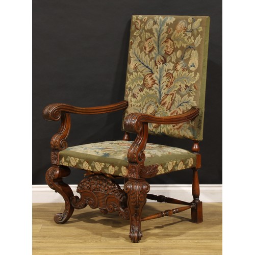 1912 - A substantial French Baroque walnut armchair, the bold scroll arms and cabriole legs carved with aca... 