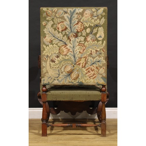 1912 - A substantial French Baroque walnut armchair, the bold scroll arms and cabriole legs carved with aca... 