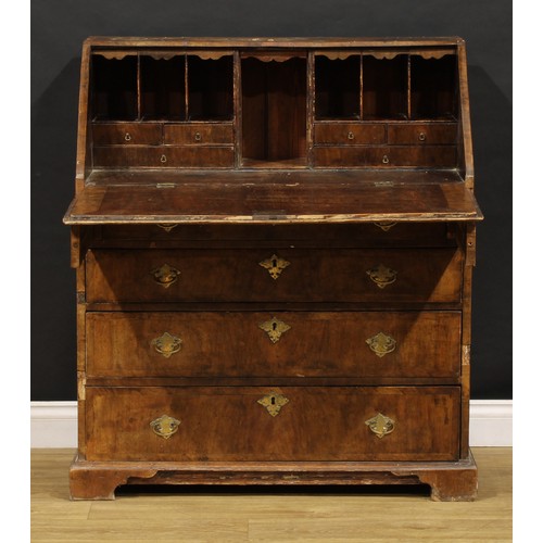 1538 - A George II crossbanded walnut bureau, fall front enclosing a fitted interior, above four long gradu... 