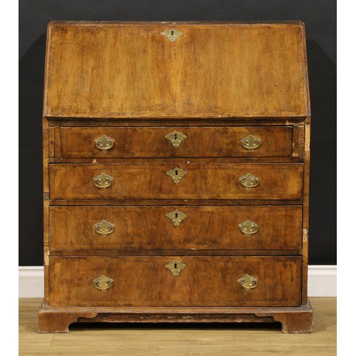 1538 - A George II crossbanded walnut bureau, fall front enclosing a fitted interior, above four long gradu... 