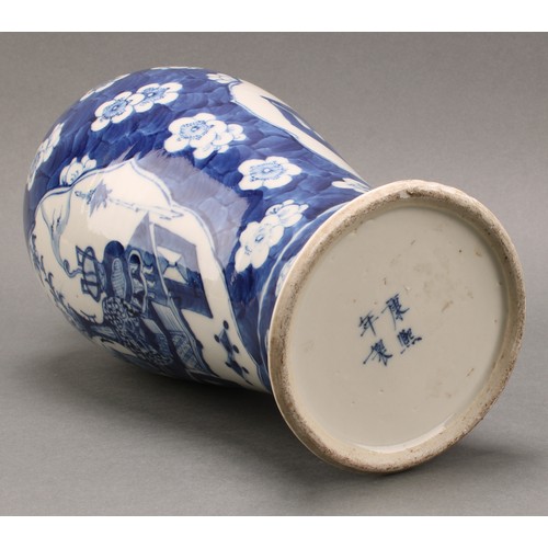 1385 - A Chinese baluster vase, painted in tones of underglaze blue with tables set with censers, planters ... 