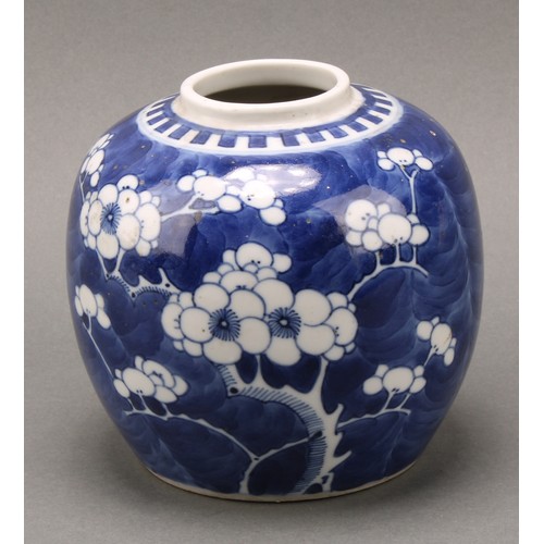 1405 - A Chinese ovoid ginger jar, painted in tones of underglaze blue with prunus on a ground of cracked i... 