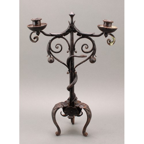 1849 - A pair of Arts and Crafts wrought iron two-light candelabra, the each pillar entwined with a serpent... 