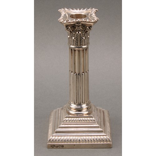 378 - A pair of Edwardian silver stop-fluted Corinthian column candlesticks, detachable nozzles, stepped b... 