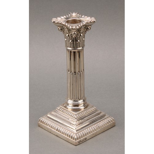 378 - A pair of Edwardian silver stop-fluted Corinthian column candlesticks, detachable nozzles, stepped b... 