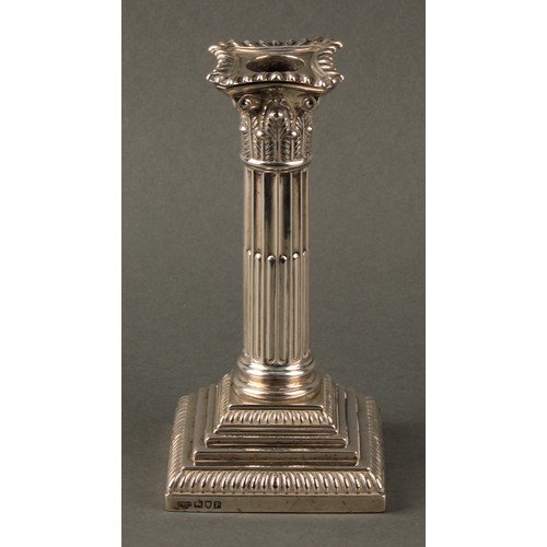 378 - A pair of Edwardian silver stop-fluted Corinthian column candlesticks, detachable nozzles, stepped b... 