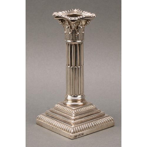 378 - A pair of Edwardian silver stop-fluted Corinthian column candlesticks, detachable nozzles, stepped b... 